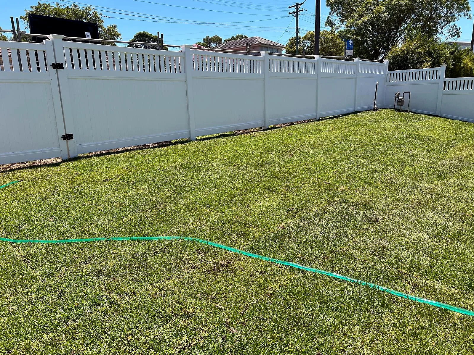 Completed natural turf across a broad Turramurra lawn beside a white fence